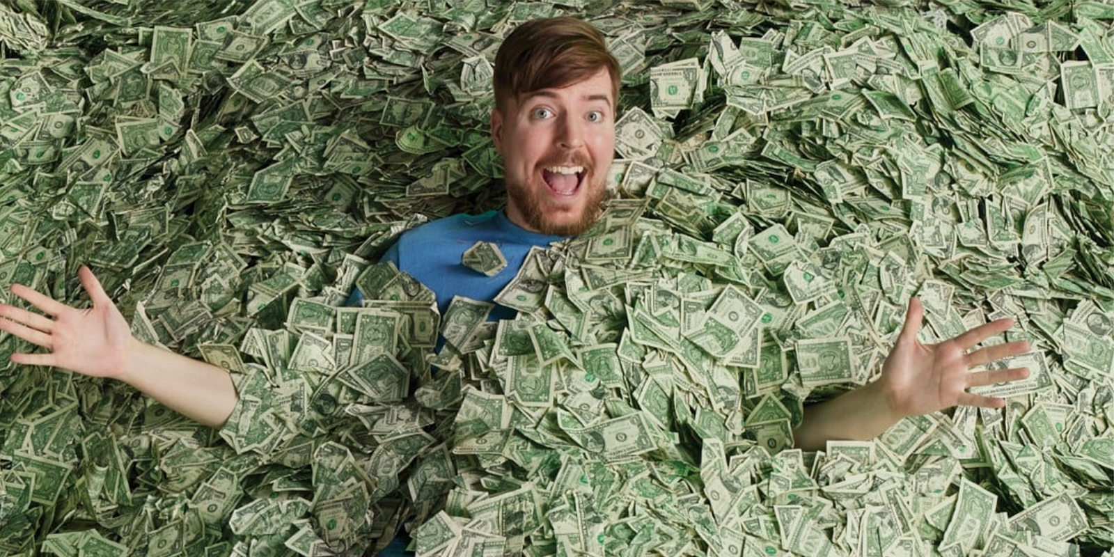 MrBeast surrounded by large piles of realistic prop money used in YouTube video productions and viral challenge content
